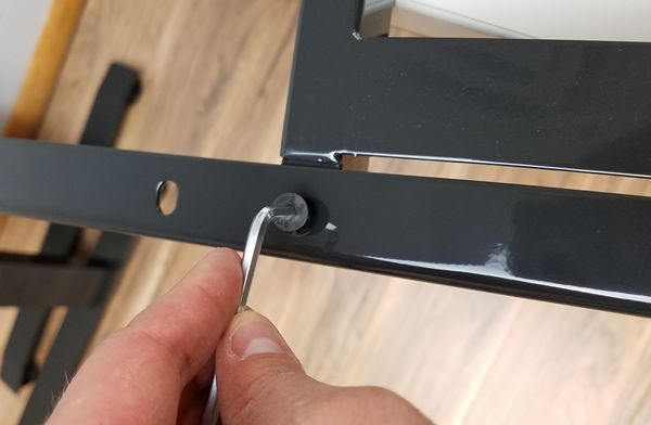One of two screws to attach desktop support to frame