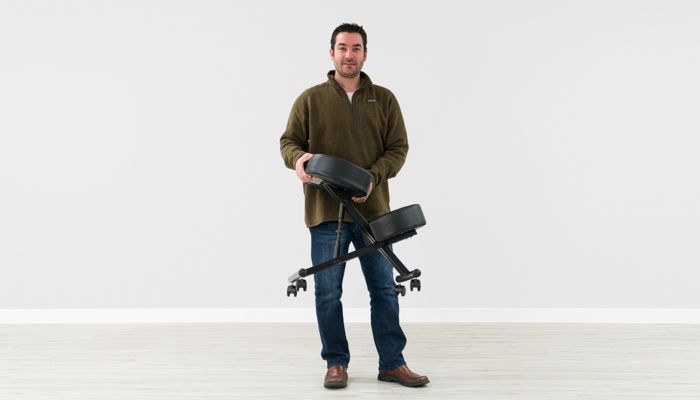 Ryan holding the Sleekform kneeling chair