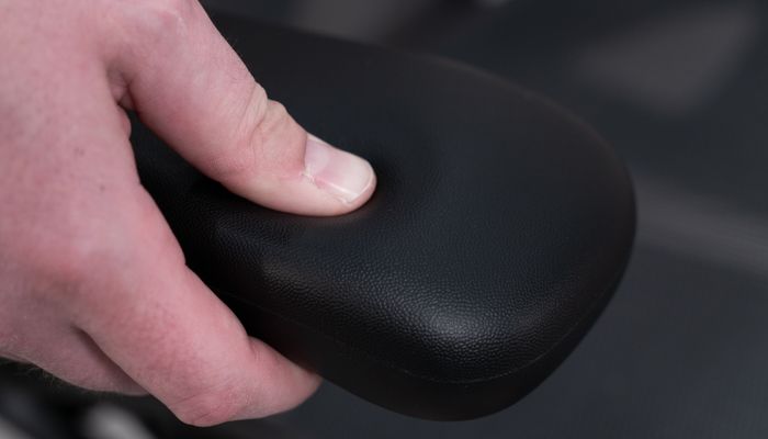 Pressing thumb into arm pad