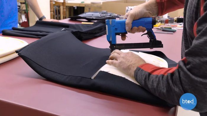 Sliding backrest material on and stapling in place