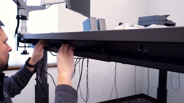 Shoving cables into the under-desk trays